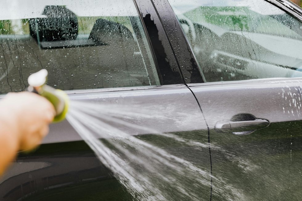A person washing their car