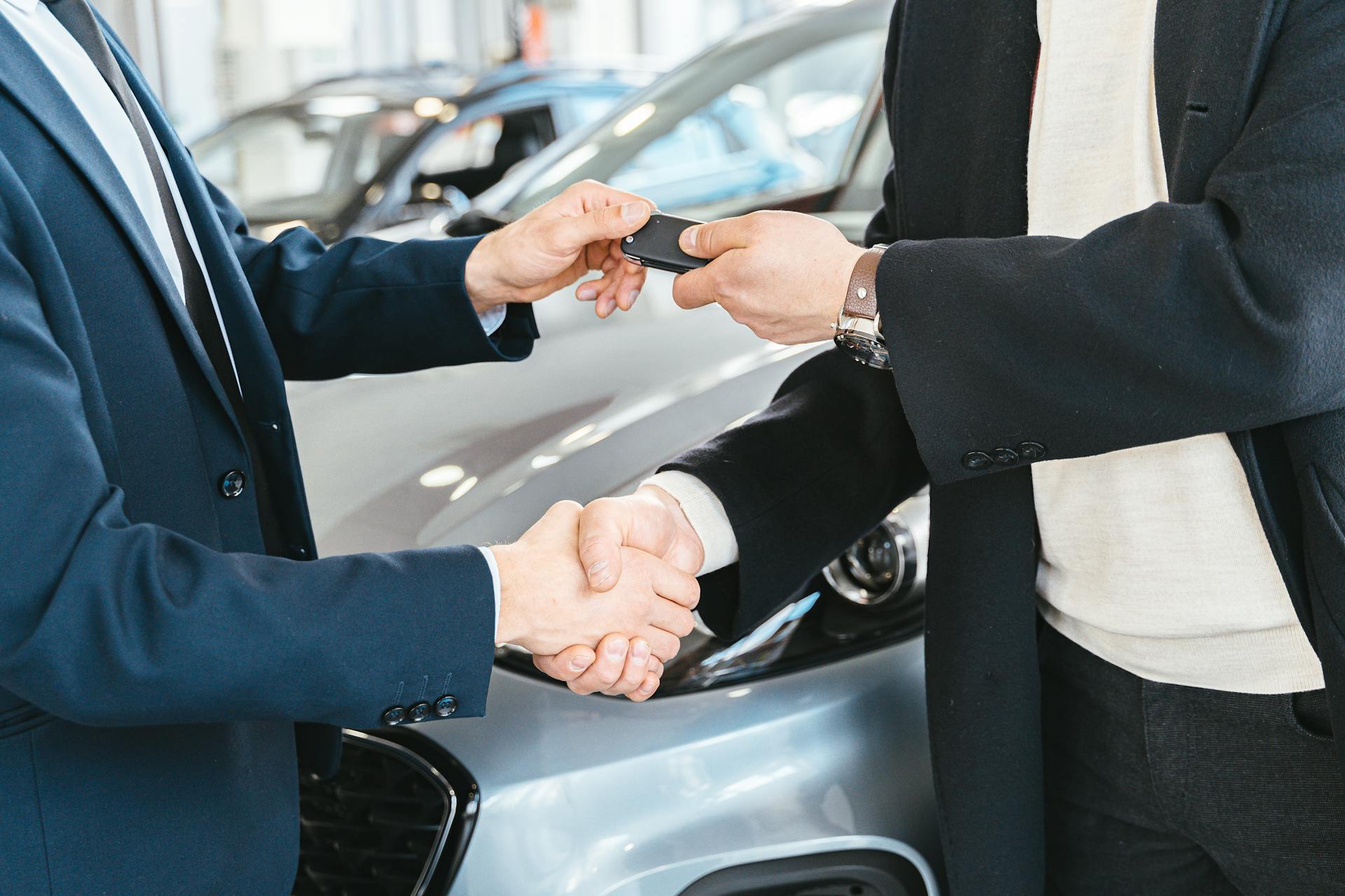 A-Person-Giving-a-Car-Key-To-Another-Person-While-Shaking-His-Hands